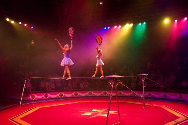 Photo: Women walking across a balance beam.