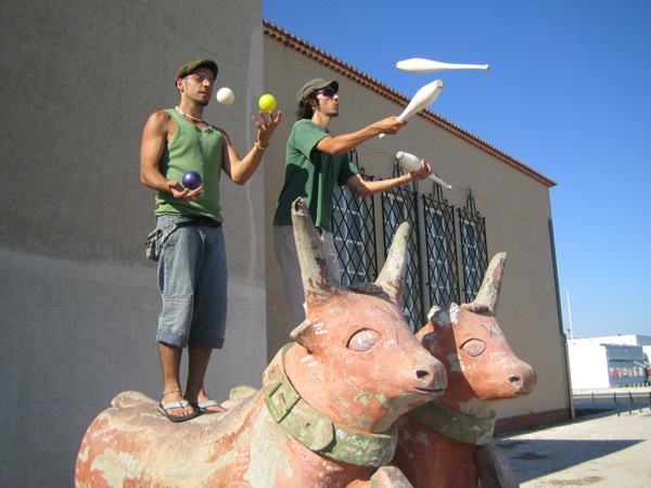 Photo: Two men juggling.