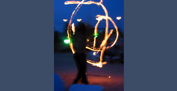 A person performing with fire poi.